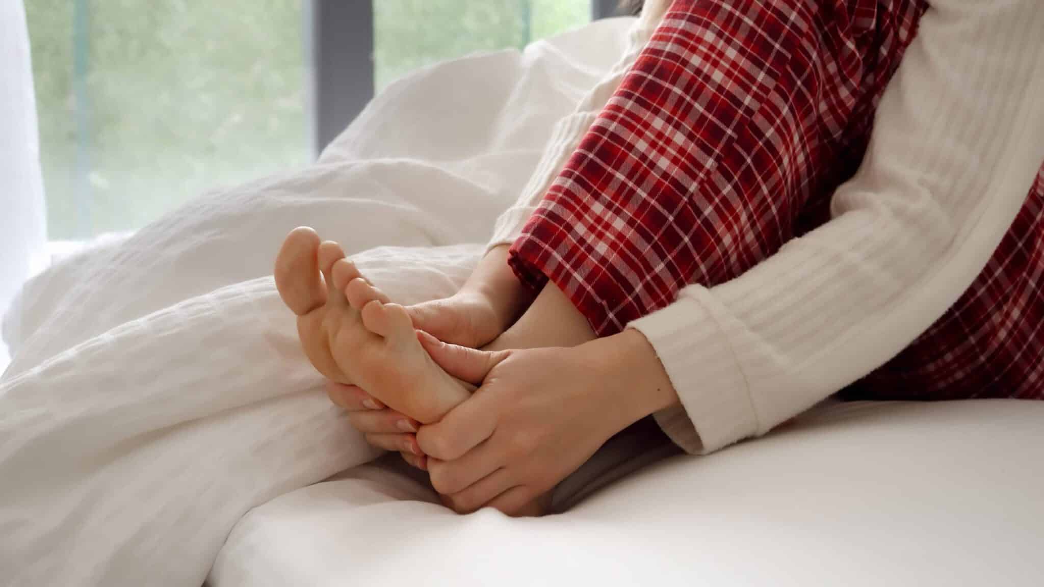 closeup of woman massaging and holding her feet af 2023 11 27 05 13 15 utc scaled 1